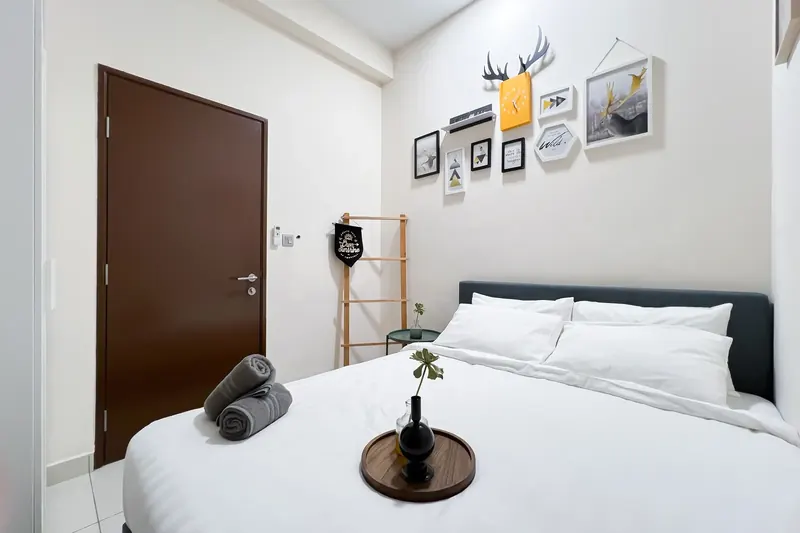 Bedroom with fresh hotel-style linen in a J Dupion Residence unit