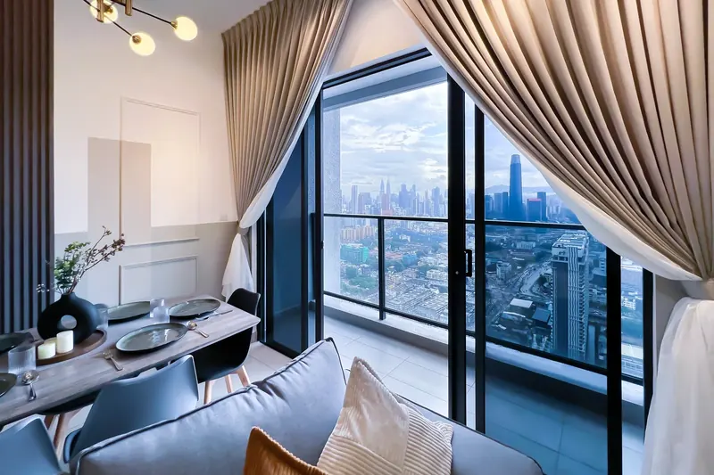 Dining area with a view of Merdeka 118 at a Trion KL unit managed by WefieHome