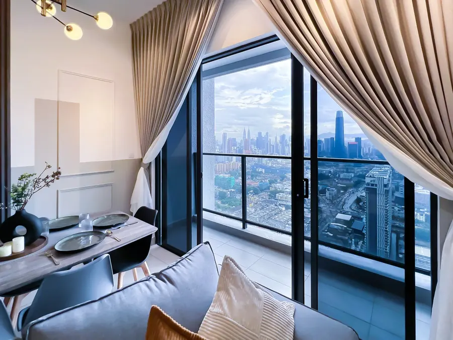 Dining area with a Kuala Lumpur skyline view in a condo managed by WefieHome