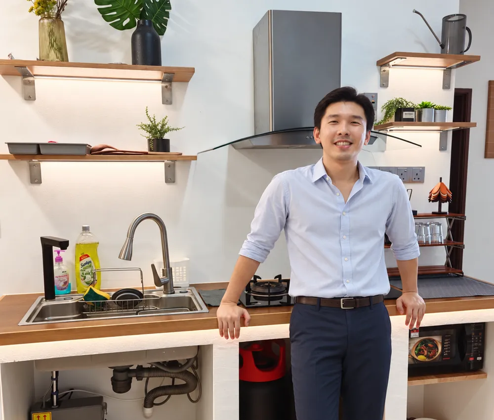 Ivan Ng, founder of WefieHome, leaning on a kitchen counter at home