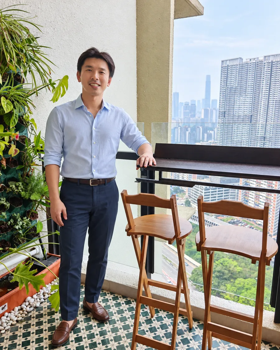 Ivan Ng, founder of WefieHome, on the balcony of a home WefieHome manages, with the Kuala Lumpur skyline behind